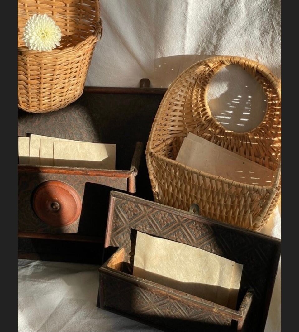 Hammered leather wall mail holder on wood.