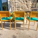 3 vintage bridge chairs with rounded armrests.