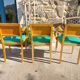 3 vintage bridge chairs with rounded armrests.