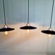 Three industrial suspensions in black enamelled sheet metal.
