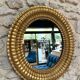 Pair of antique oval mirrors gilded with gold leaf and mercury.