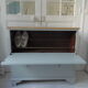 Vintage shoe cabinet green of gray, wooden top.