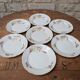 7 dessert plates in porcelain with a violet lilac design and a gold rim.