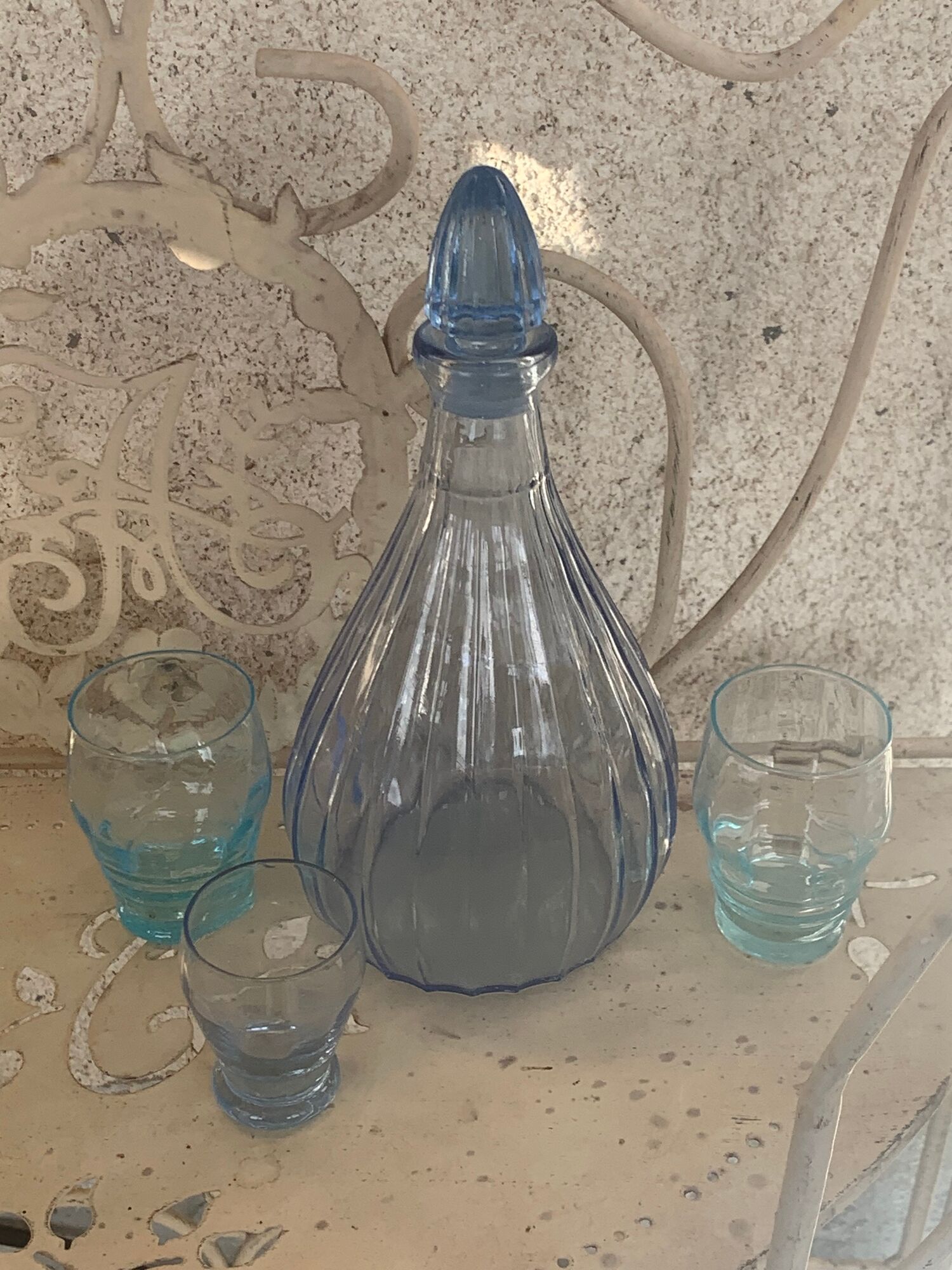 Liquor service consisting of a blue glass decanter and. 3 small antique glasses