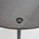 Round dining table in black lacquered metal with a granite top.