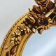 Large gold full-length mirror with ornate crest