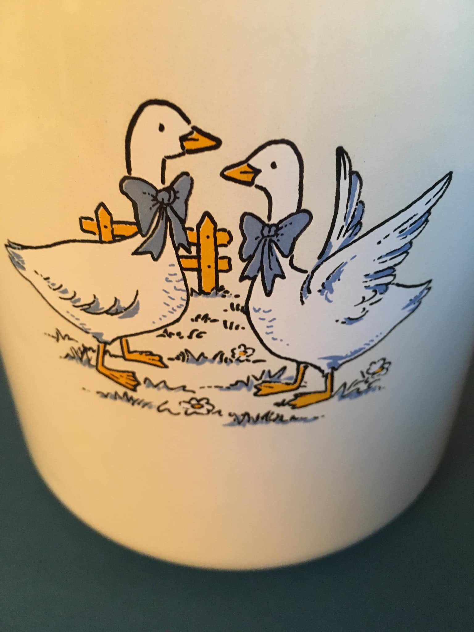 Enamelled milk jar retro style ecru color with "goose" patterns. Wooden handle.
