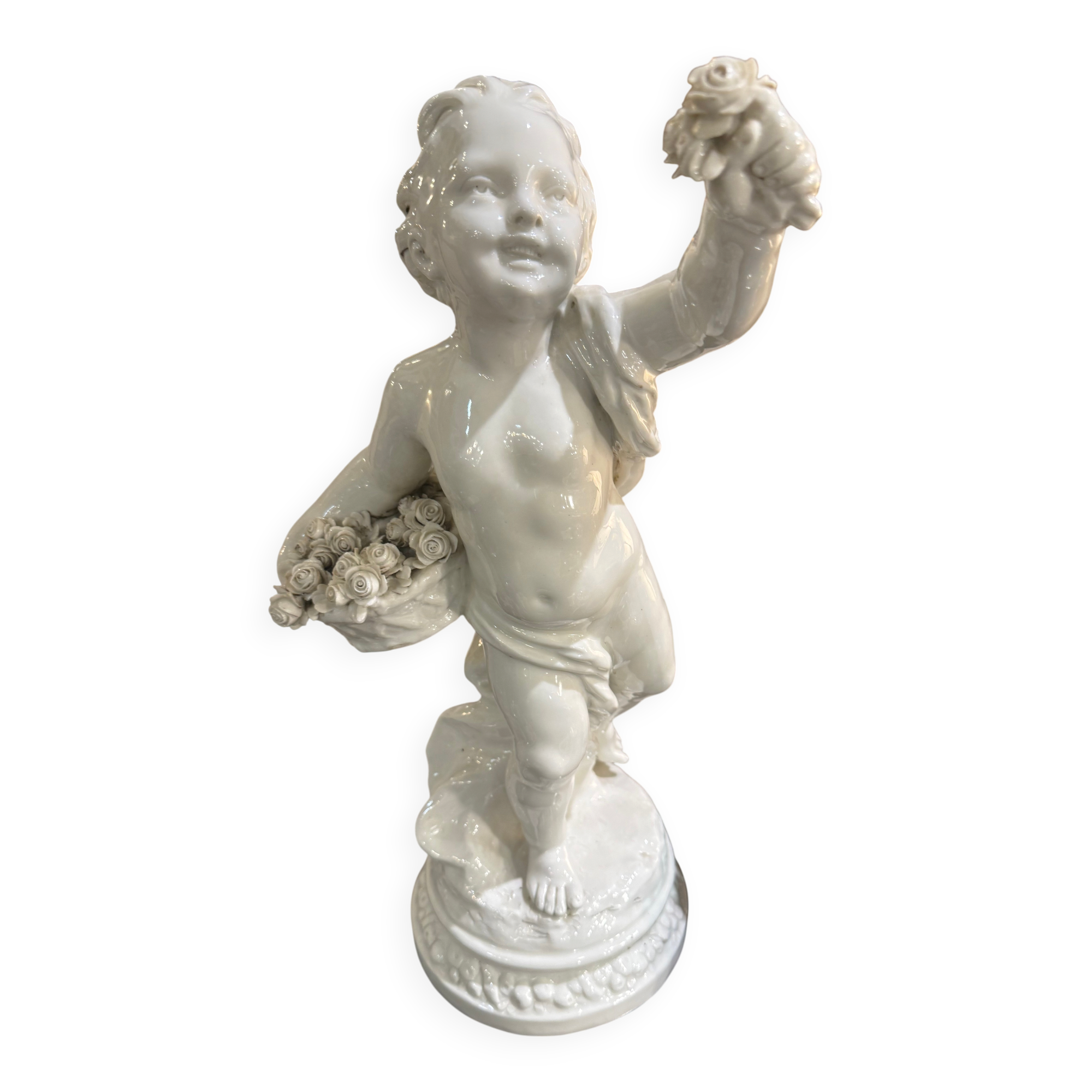 Child statue with flowers in porcelain, signed.