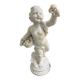 Child statue with flowers in porcelain, signed.