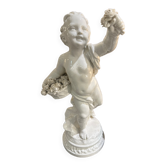 Child statue with flowers in porcelain, signed.