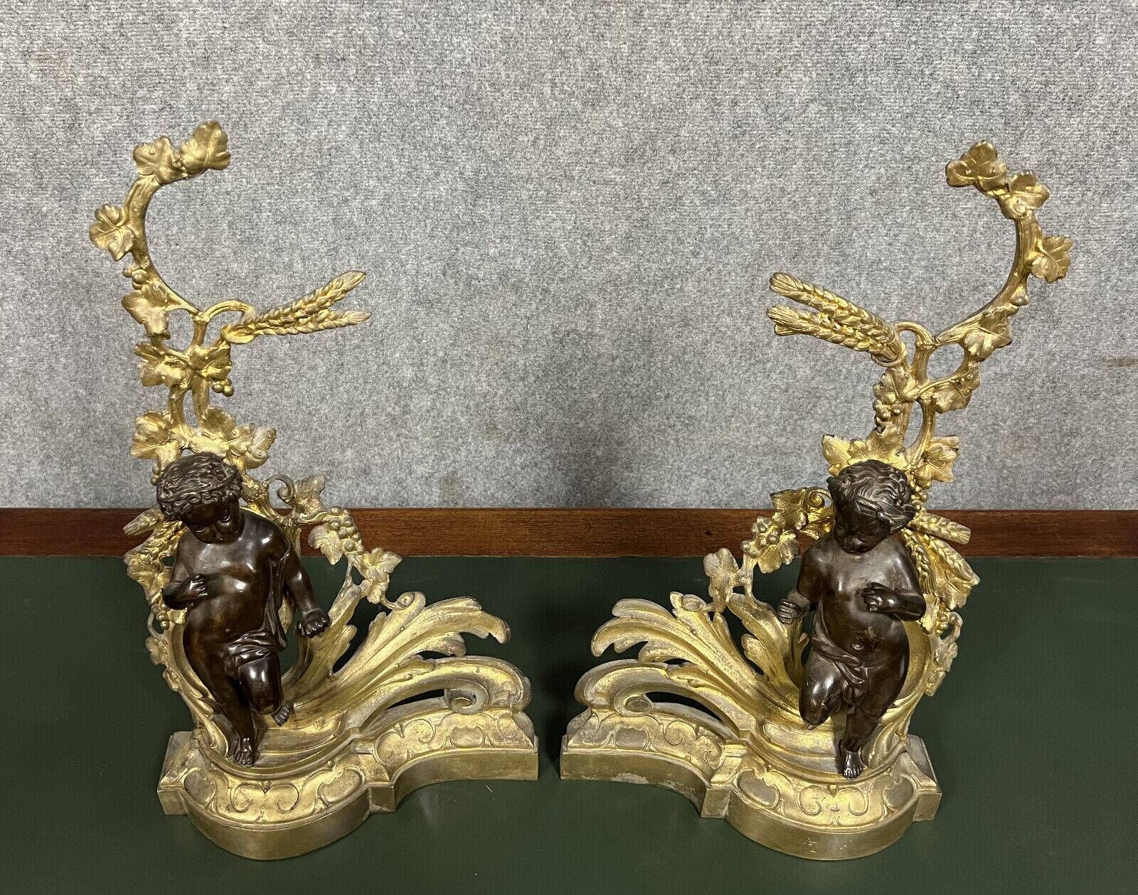Pair of gilded bronze and patinated bronze andirons depicting putti circa 1850