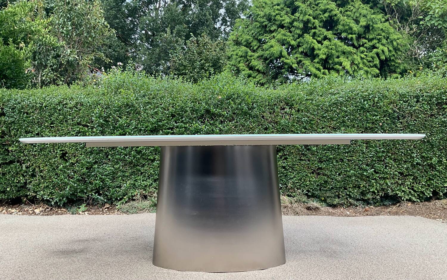 Oval designer dining table in frosted glass and brushed stainless steel