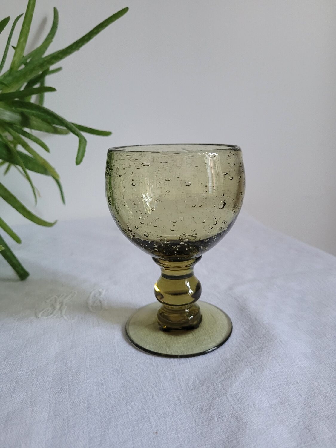 Footed glass made of blown glass