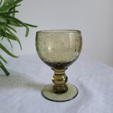 Footed glass made of blown glass