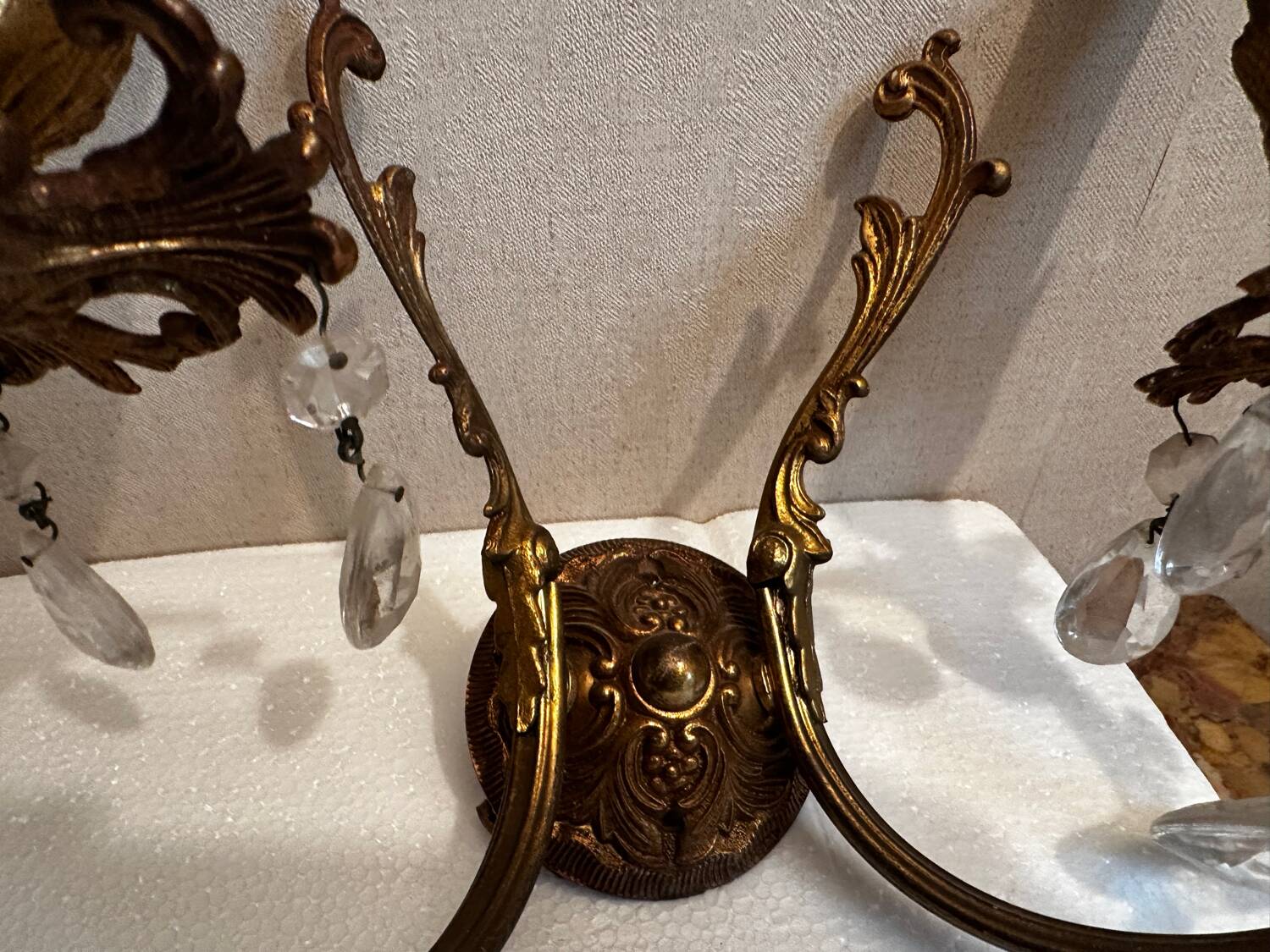 Pair of Louis XV style wall sconces in gilded bronze with glass pendants.