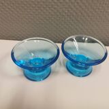 Two small candle holders in blue glass from the well-known Finnish company Ittala.