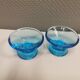 Two small candle holders in blue glass from the well-known Finnish company Ittala.