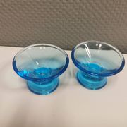 Two small candle holders in blue glass from the well-known Finnish company Ittala.