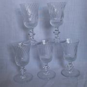 Ancient footed crystal glasses with relief twisted fluted goblets.