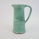 Large green ceramic pitcher with leopard enamel