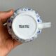 White porcelain milk jug with blue floral designs.