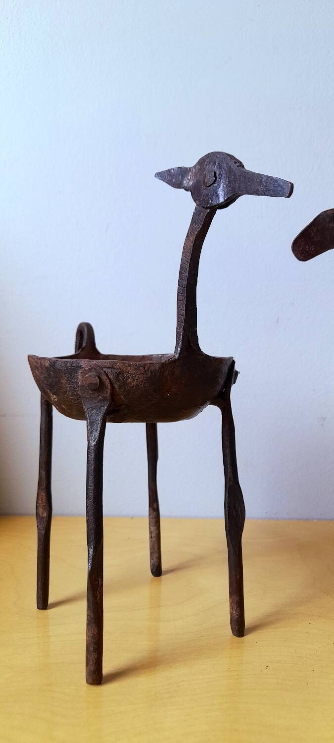 Zoomorphic wrought iron pocket emptier