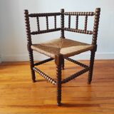 Antique corner chair made of turned wood spindle.