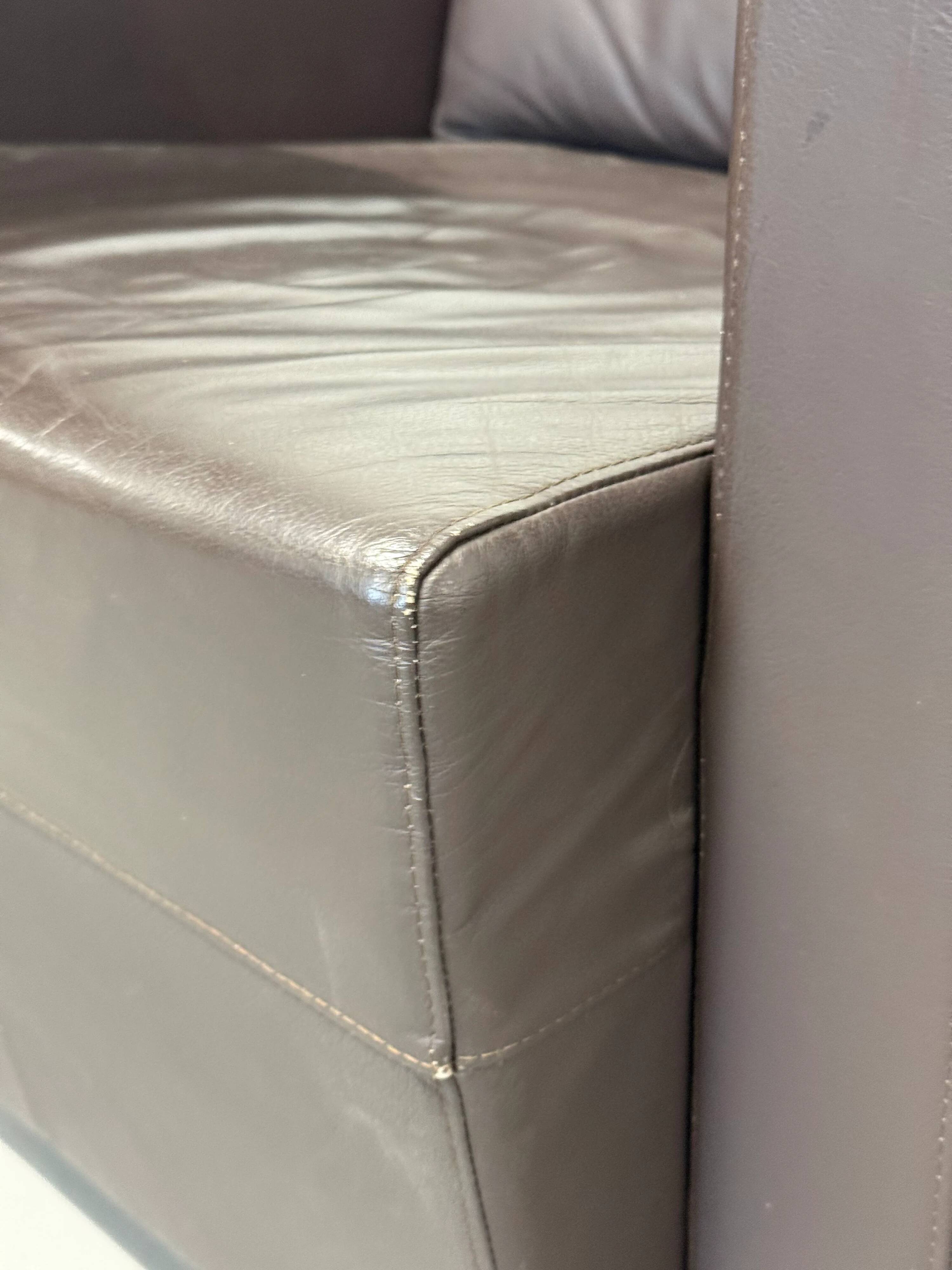 Vintage brown leather club armchair with a swivel side table.