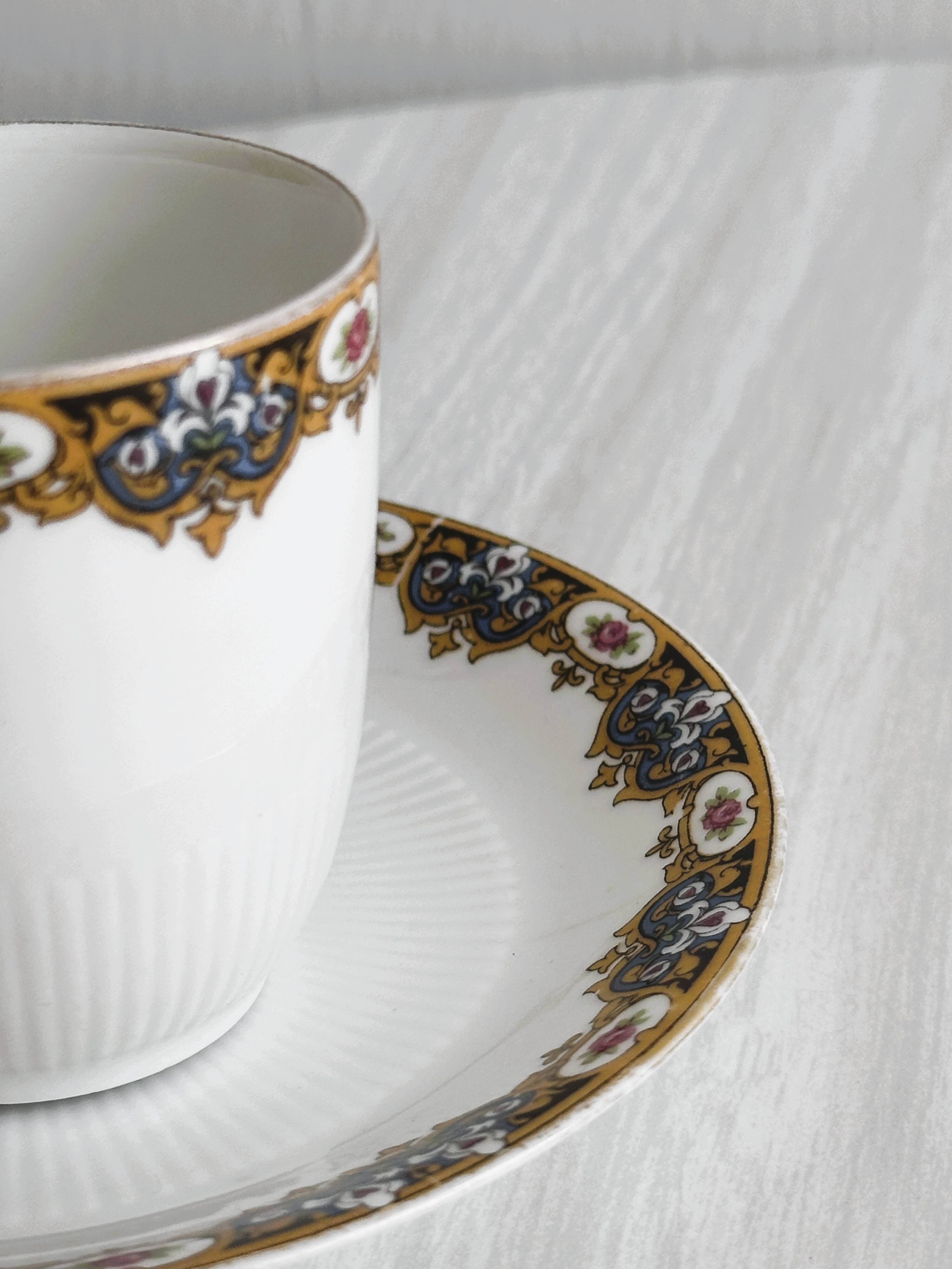 7 Limoges porcelain cups and saucers with gold decoration and floral motif.