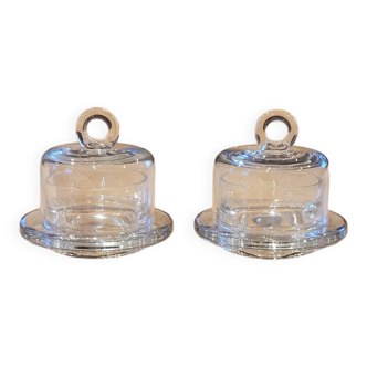 2 transparent glass butter dishes with dome