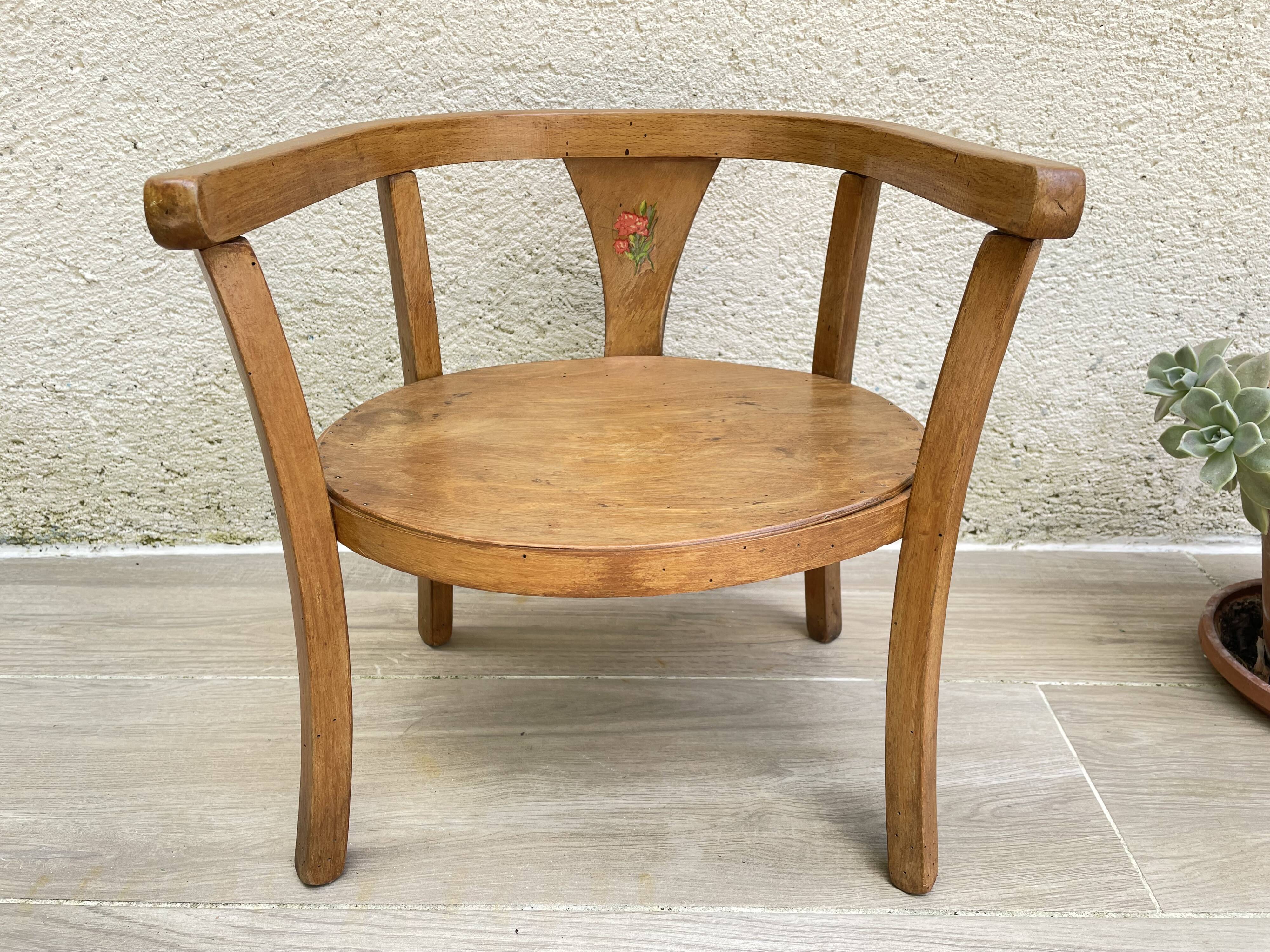 Old armchair for children in wood