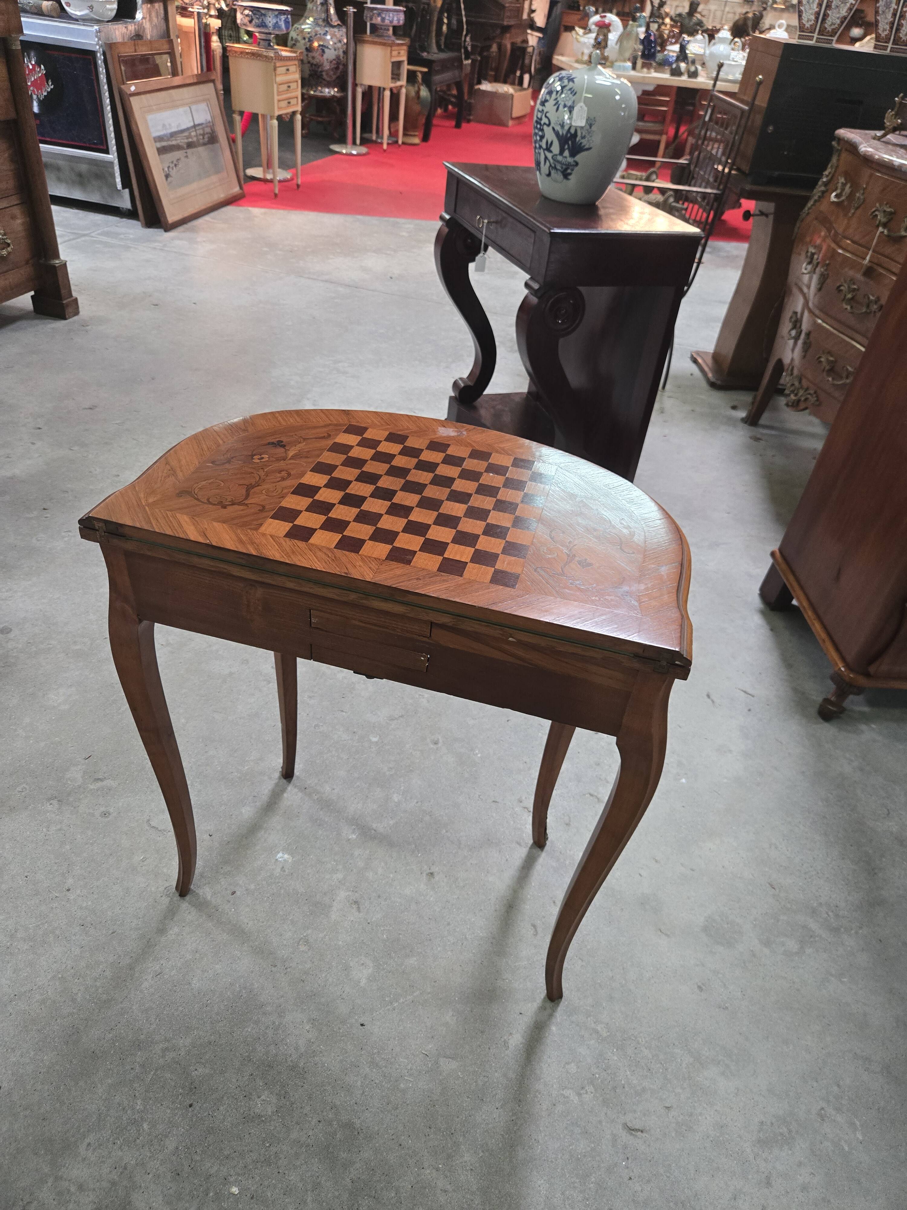 Half-moon gaming table in Louis XV style, made of precious wood marquetry.