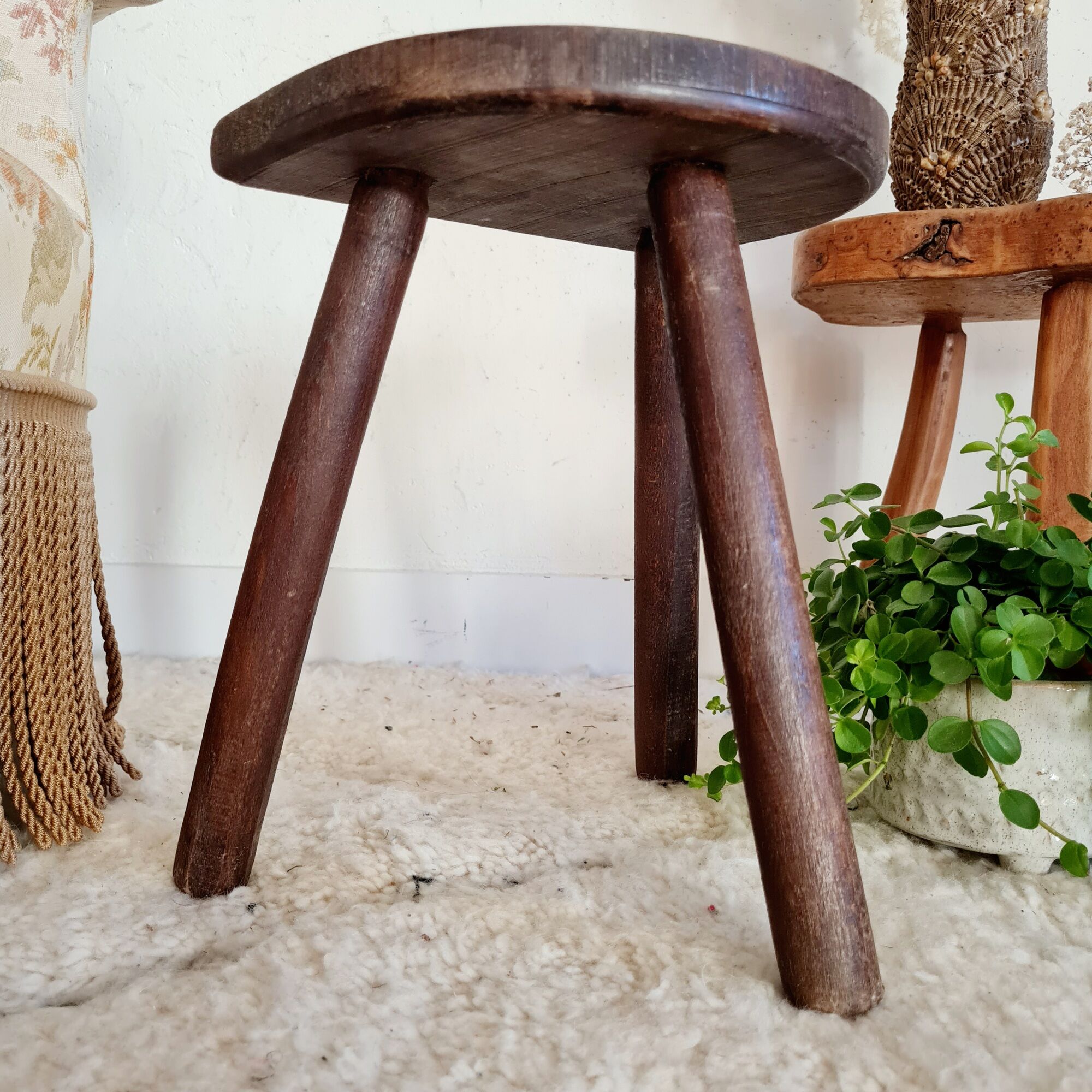 Old wooden tripod wooden farm stool made of wood