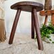 Old wooden tripod wooden farm stool made of wood
