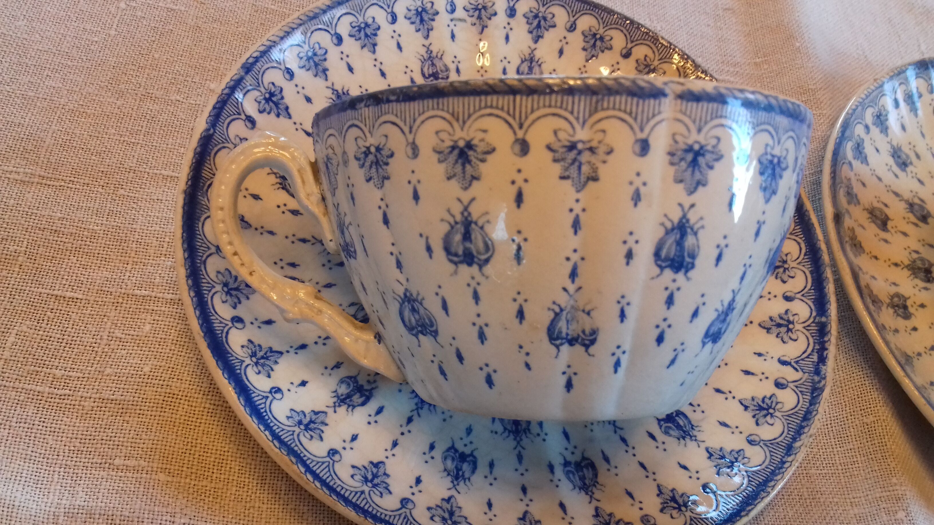 2 old coffee cups with their saucer, with blue bee patterns