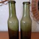 Pair of green bottles made of bubbled blown glass