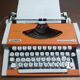 Olympia traveller luxury typewriter orange revised and new ribbon