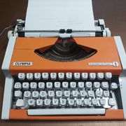 Machine à écrire Olympia traveller de luxe orange révisé et ruban neuf