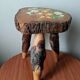 Tripod stool plant holder with hand-painted floral design.