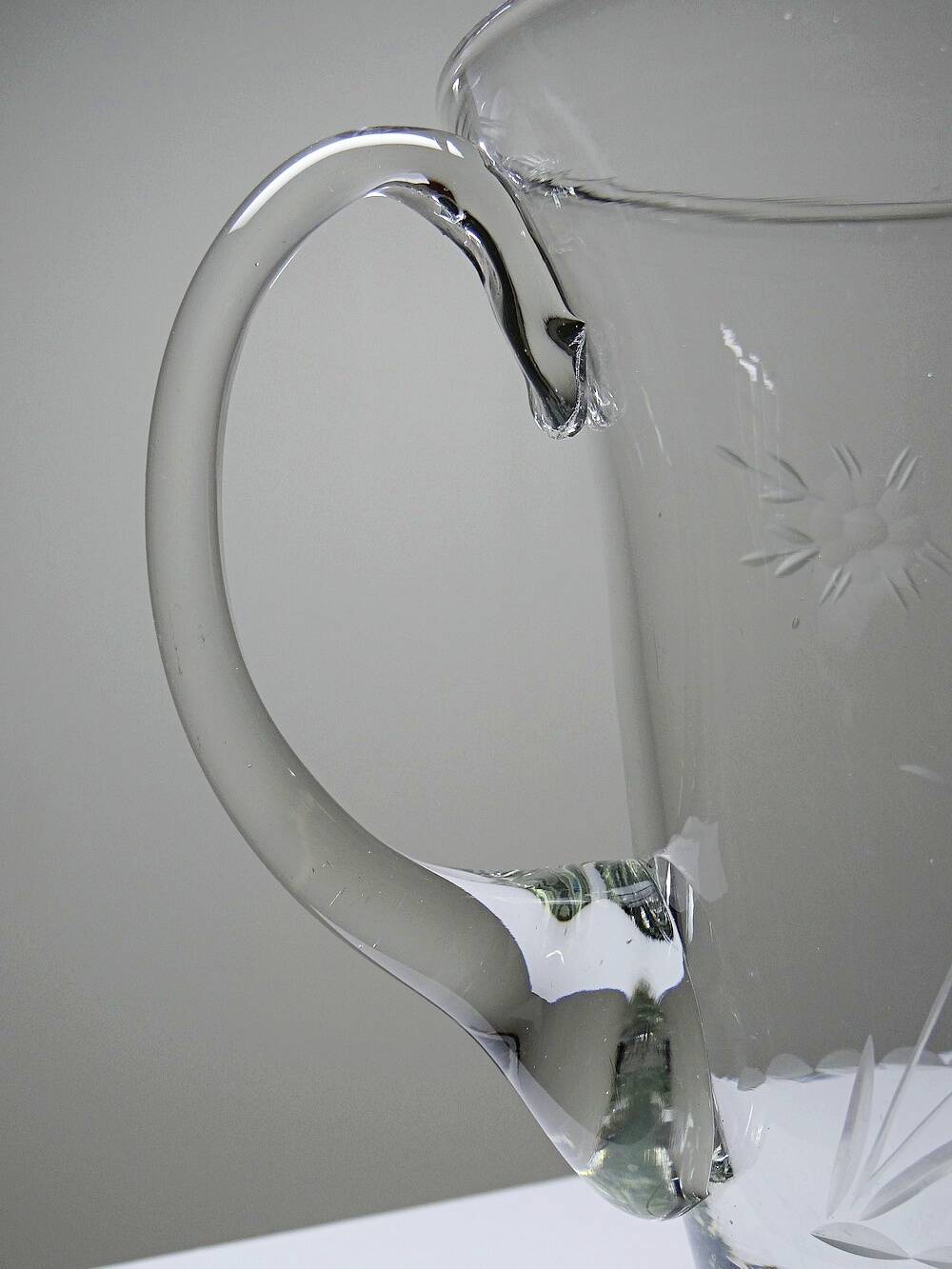 Antique glass pitcher with wheel engraving and floral decoration, Bohemia, early 20th century.