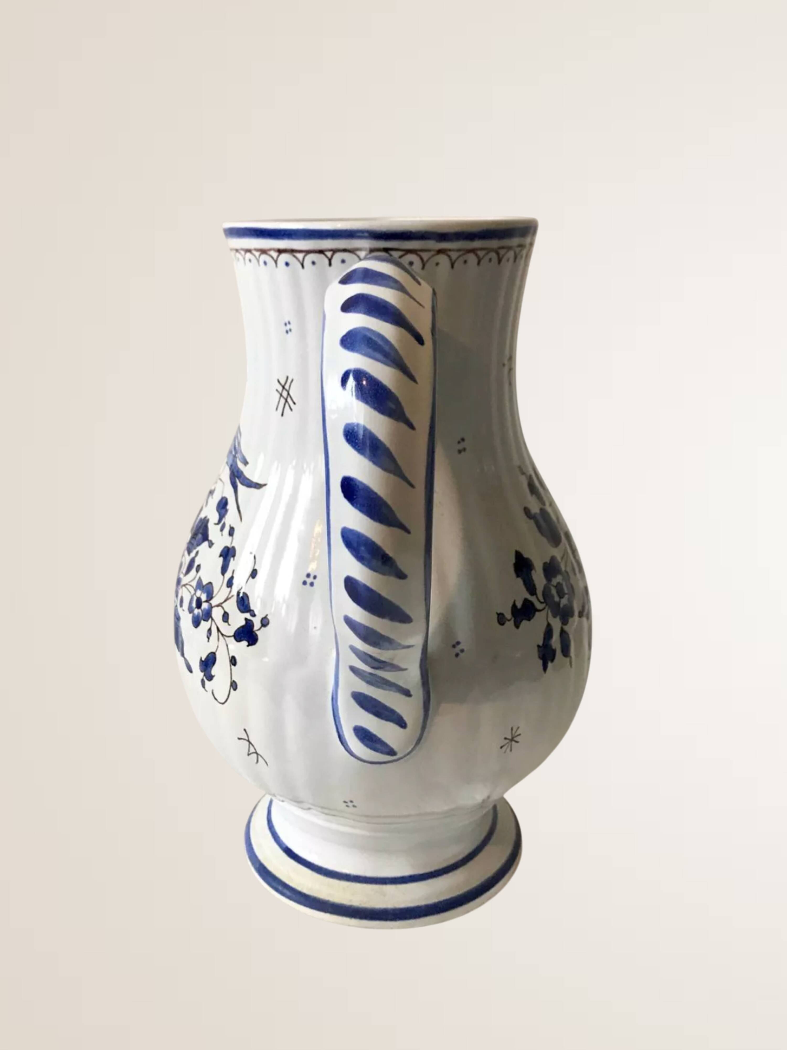 Moutiers earthenware jug, hand-painted blue decoration.