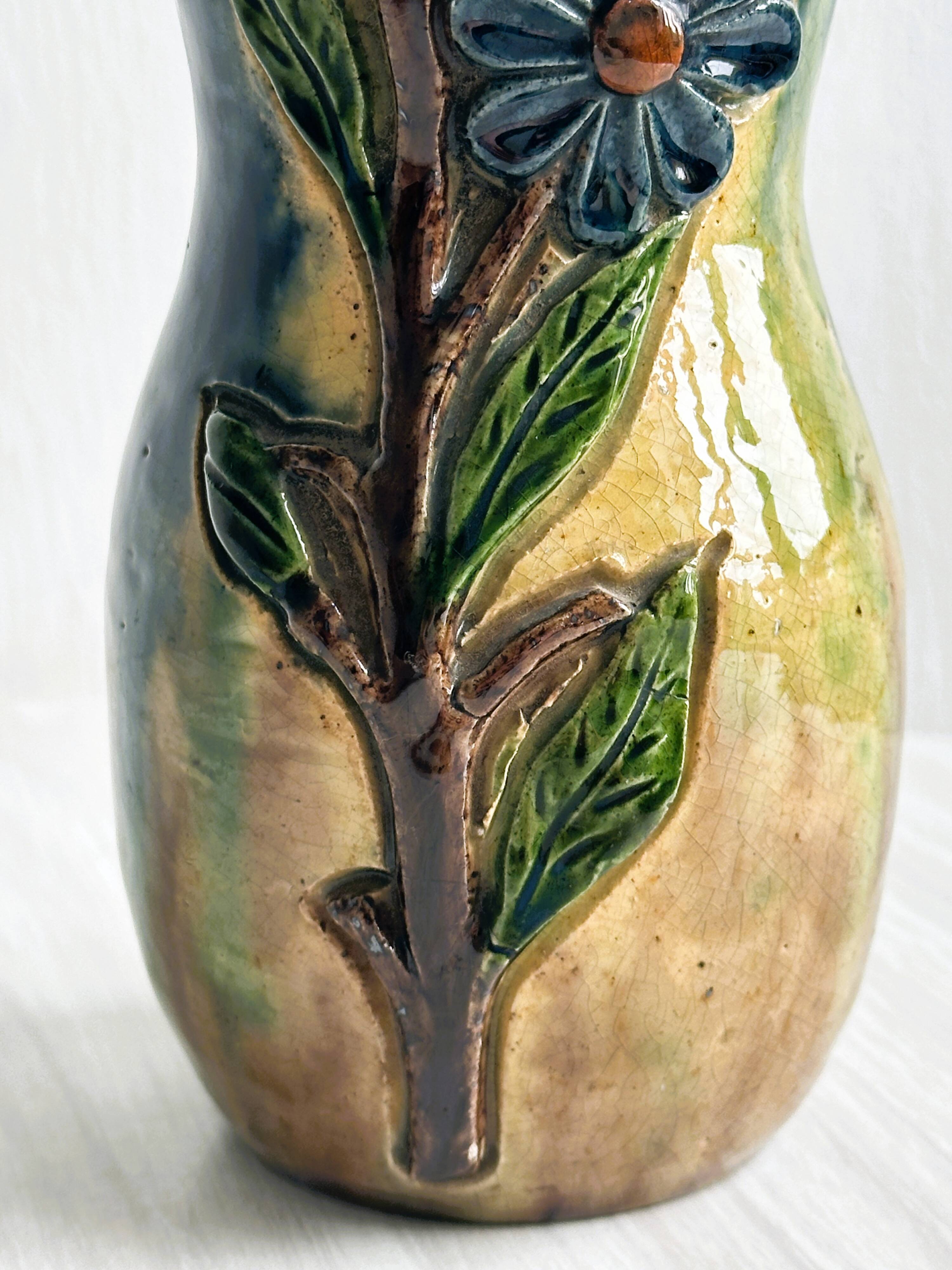 Very colorful glazed earthenware vase, old vase with floral decoration.
