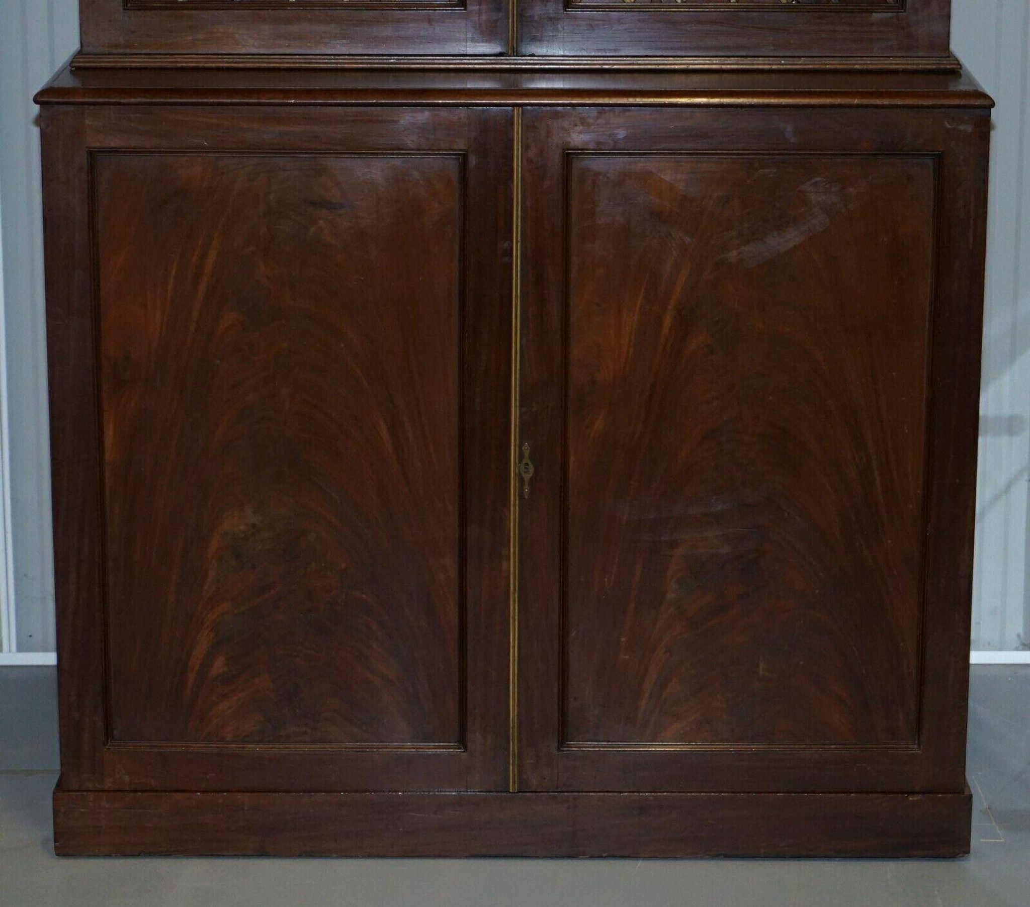 19th-century hardwood library with bronze metal doors and a chest of drawers.