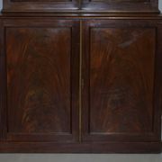 19th-century hardwood library with bronze metal doors and a chest of drawers.