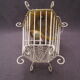 Vintage suspension cage has metal birds and raffia