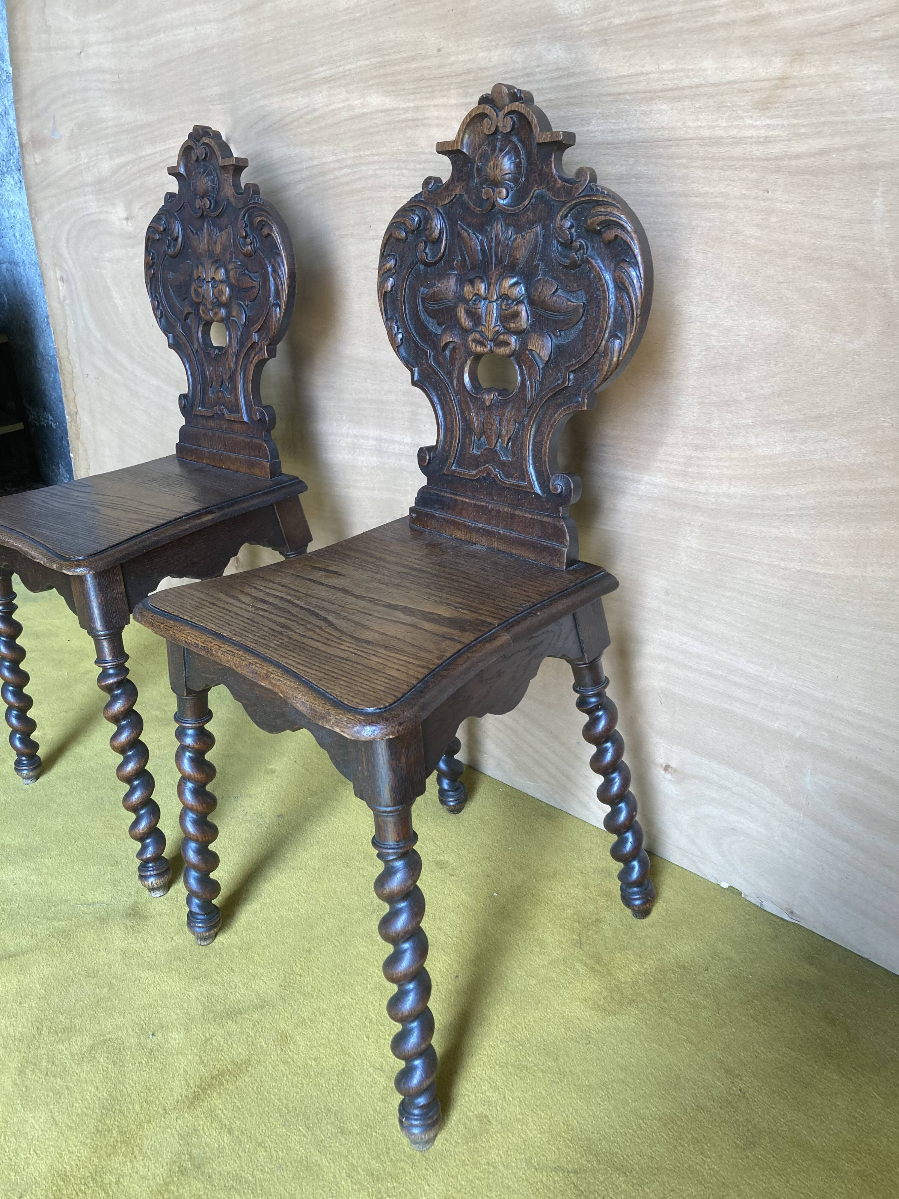 Duo of carved wooden chairs