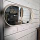 Oval mirror in white lacquer from the 1970s.