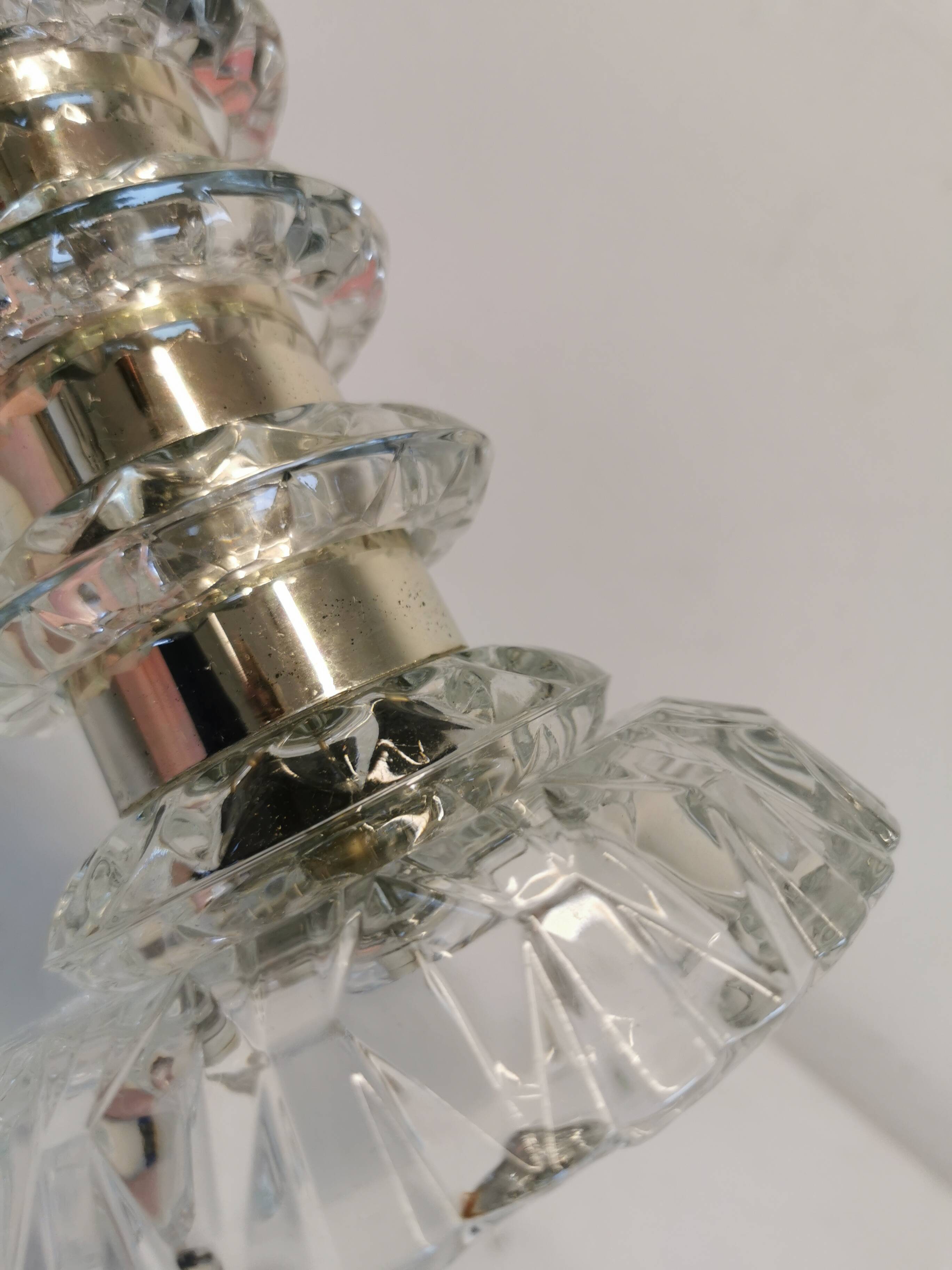 Table lamp made of transparent crystal glass and silver colored spacers.
