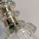 Table lamp made of transparent crystal glass and silver colored spacers.