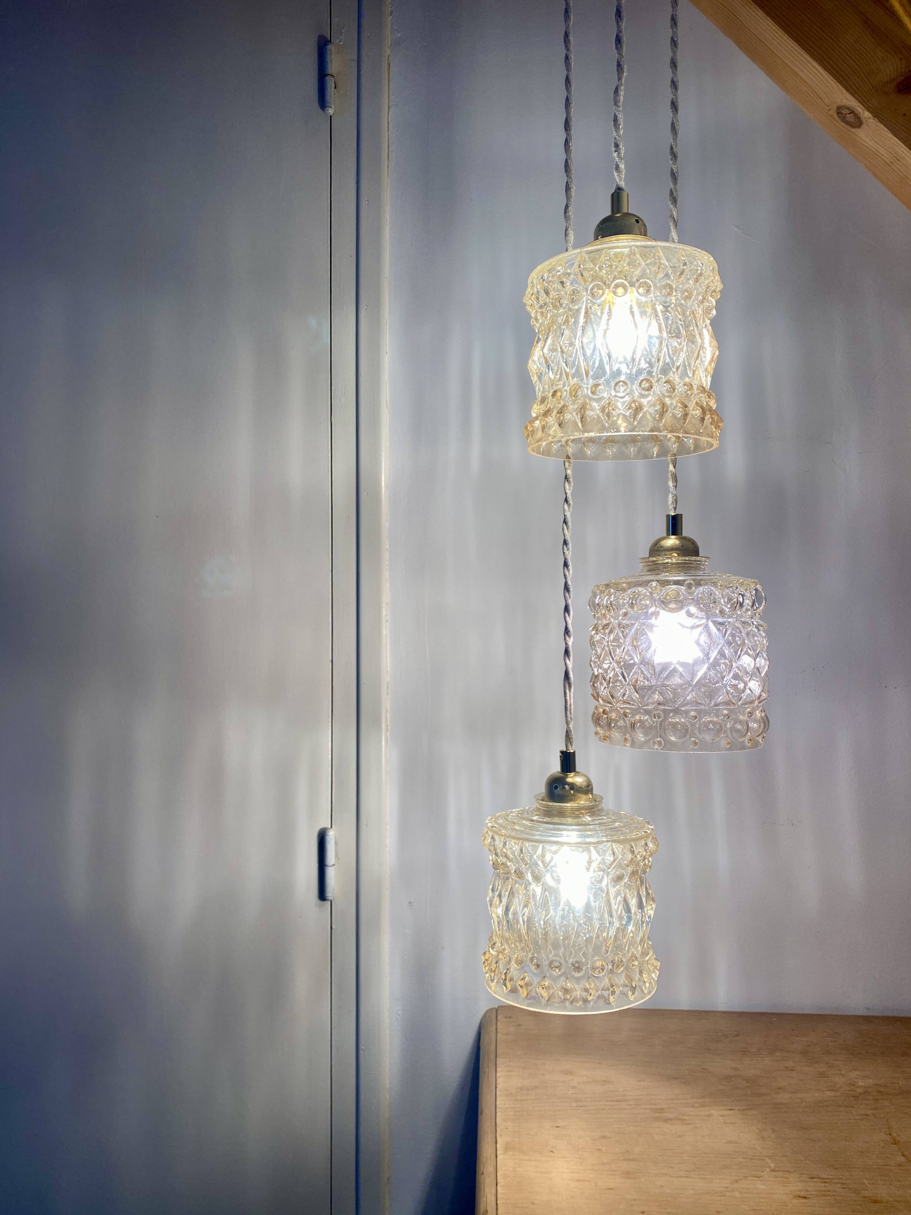 Triple antique globe pendant light in amber glass